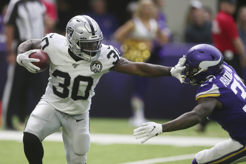 Oakland Raiders running back Jalen Richard (30) tries to break a tackle by Minnesota Vikings running back Ameer Abdullah, right, during the first half of an NFL football game, Sunday, Sept. 22, 2019, in Minneapolis. (AP Photo/Jim Mone)