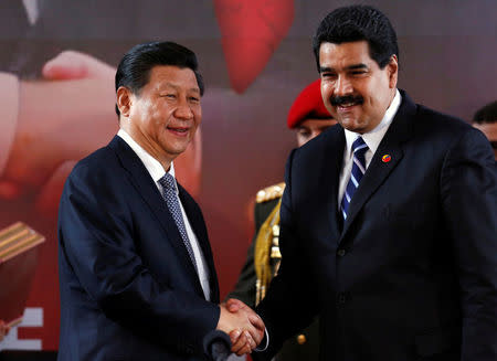 FILE PHOTO: China's President Xi Jinping (L) and Venezuela's President Nicolas Maduro shake hands during a signing ceremony in Caracas July 21, 2014. REUTERS/Carlos Garcia Rawlins/File Photo