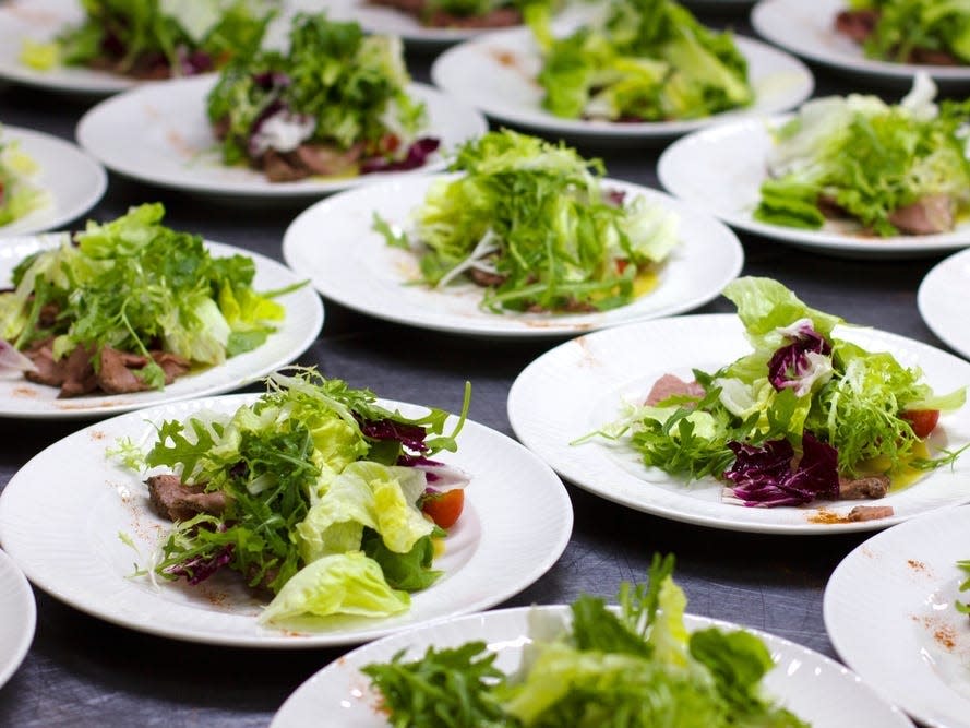 white plates on a table with green salad