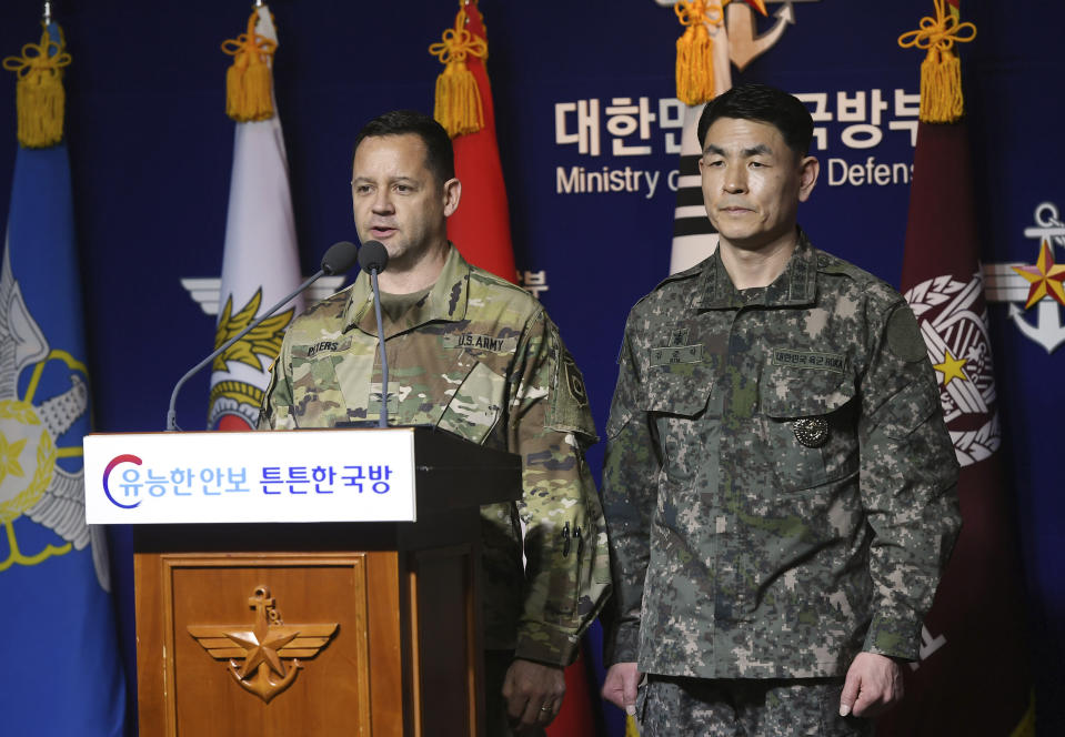 U.S. Army's Col. Lee Peters, director of Public Affairs of United States Forces Korea, and Col. Kim Jun-rak, of South Korea's Joint Chiefs of Staff brief about the their postponed joint militaries drills to the media at Defense Ministry in Seoul, South Korea, Thursday, Feb. 27, 2020. The South Korean and U.S. militaries have postponed their annual joint drills out of concerns over a virus outbreak. (Korea Pool/Yonhap via AP)