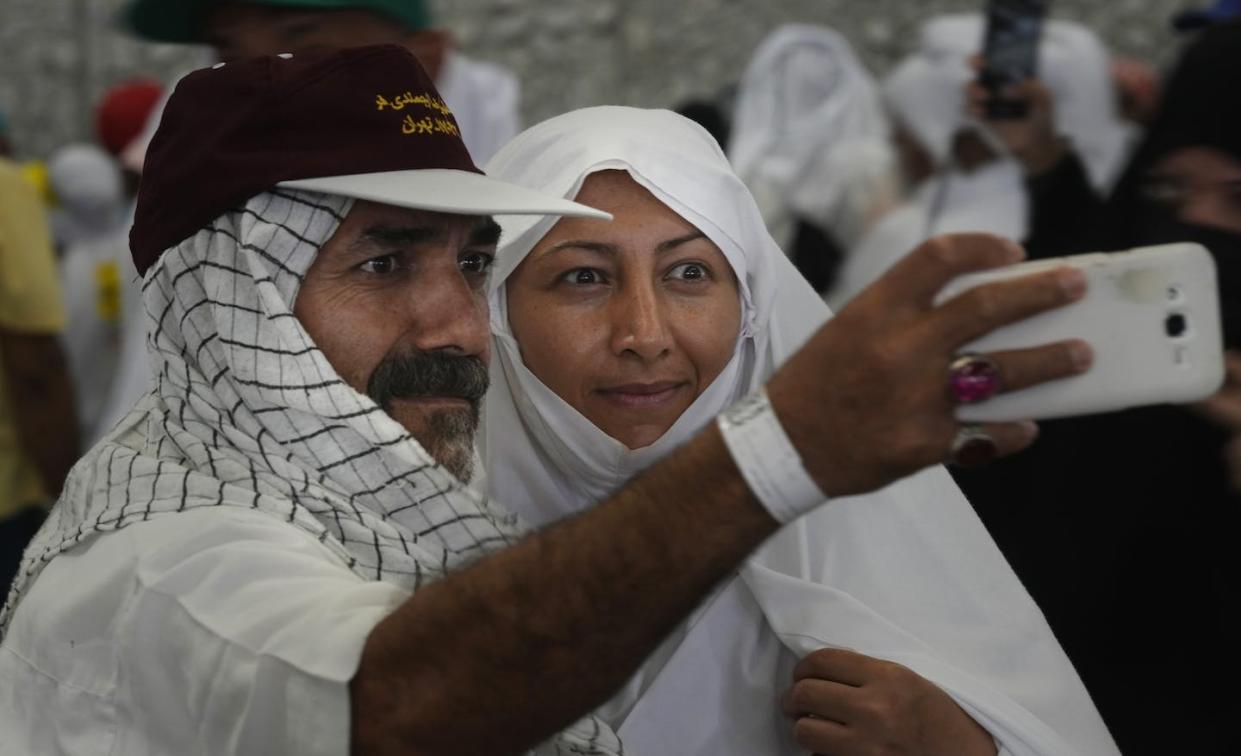 Iranian pilgrims pose for a selfie during the hajj pilgrimage in 2022. <a href="https://newsroom.ap.org/detail/SaudiArabiaHajj/00c994b4debf44c18cd331df8cac397a/photo" rel="nofollow noopener" target="_blank" data-ylk="slk:AP Photo/Amr Nabil;elm:context_link;itc:0;sec:content-canvas" class="link ">AP Photo/Amr Nabil</a>