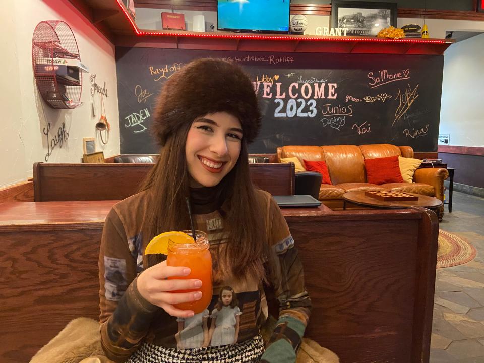 Paris Barraza tries a fruity mocktail at Burger Haul, a restaurant and bar in downtown Iowa City, Jan. 21.