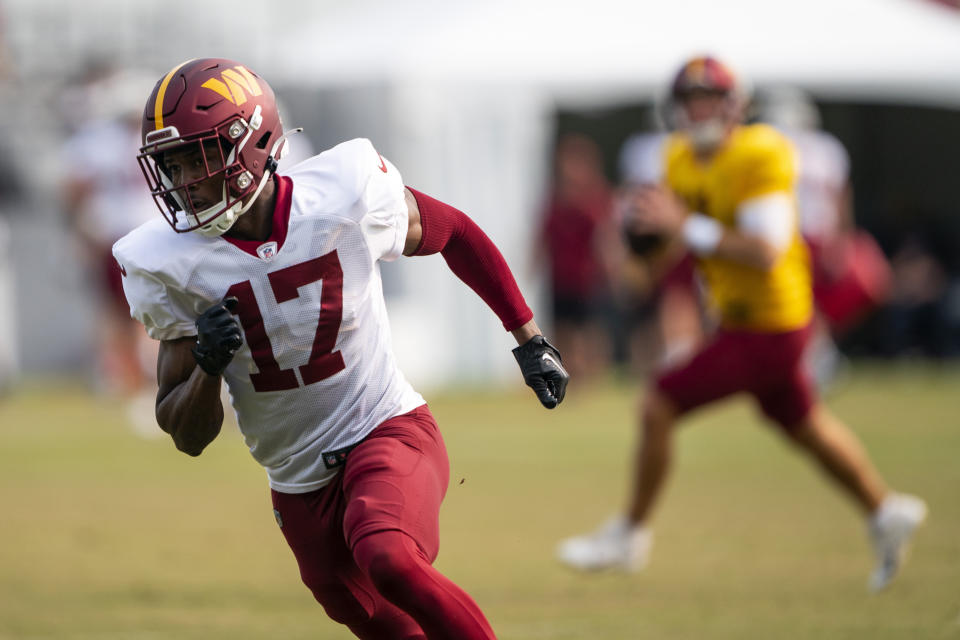 Washington Commanders wide receiver Terry McLaurin, left, runs a route for quarterback Sam Howell during an NFL football practice at the team's training facility, Tuesday, Aug. 1, 2023, in Ashburn, Va. (AP Photo/Evan Vucci)