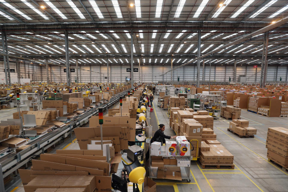 PETERBOROUGH, ENGLAND - NOVEMBER 28:  Employees select and dispatch items in the huge Amazon 'fulfilment centre' warehouse on November 28, 2013 in Peterborough, England. The online retailer is preparing for 'Cyber Monday', as it predicts the busiest day for online shopping in the UK will fall on Monday December 2nd this year. On Cyber Monday in 2012 amazon.co.uk recorded over 3.5 million individual items ordered, which equates to 41 items purchased per second. The Peterborough fulfilment centre is 500,000 sq ft, equivalent to approximately seven football pitches in floor area. Amazon are due to employ more than 1,000 seasonal staff to cope with increased demand in the run up to Christmas.  (Photo by Oli Scarff/Getty Images)