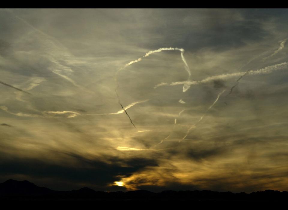 At sunset military aircraft contrails in the skies above Area 51 and the U.S.Air Force air weapons range near the town of Rachel and the UFO Highway (hwy. 375) . (CP PHOTO/Larry MacDougal)