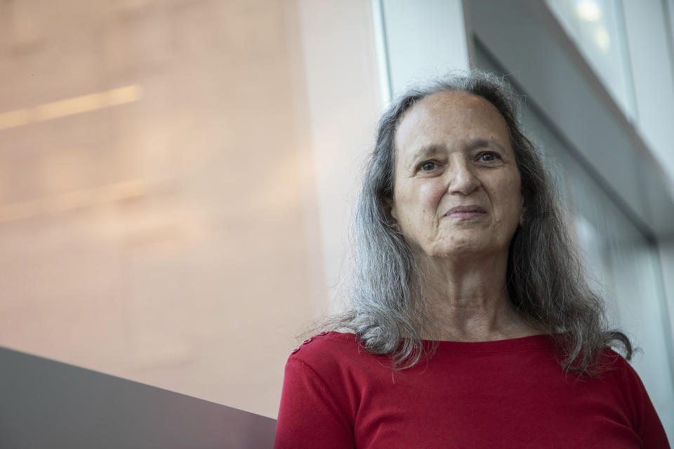 In this Monday, Oct. 18, 2021 photo, Carol Black, a survivor of the Oct. 27, 2018, mass shooting at the Tree of Life synagogue, poses for a portrait at the Eradicate Hate Global Summit in Pittsburgh. Black's brother, Richard Gottfried, was killed along with 10 other people in the attack. (AP Photo/Rebecca Droke)