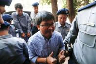 Detained Reuters journalist Wa Lone and Kyaw Soe Oo are escorted by police while arriving for a court hearing in Yangon, Myanmar February 1, 2018. REUTERS/Jorge Silva/Files