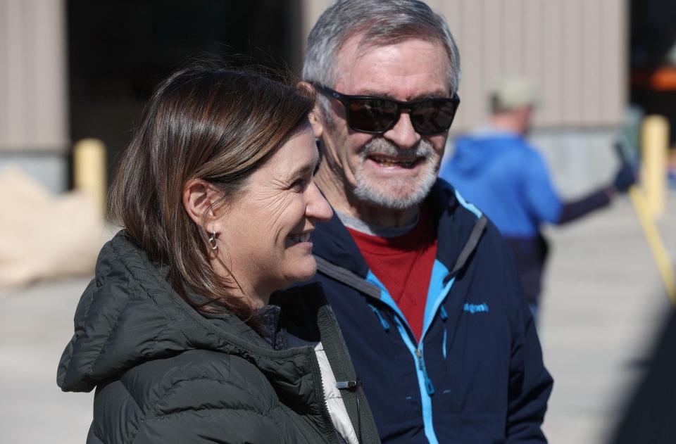 Salt Lake County Mayor Jenny Wilson and her father, former Salt Lake City Mayor Ted Wilson, talk about volunteers assisting to fill sandbags in Midvale on Friday.