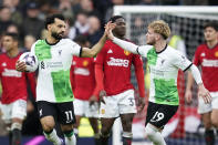 Liverpool's Mohamed Salah, left, celebrates with Harvey Elliott after scoring his side's second goal during the English Premier League soccer match between Manchester United and Liverpool at the Old Trafford stadium in Manchester, England, Sunday, April 7, 2024. (AP Photo/Dave Thompson)