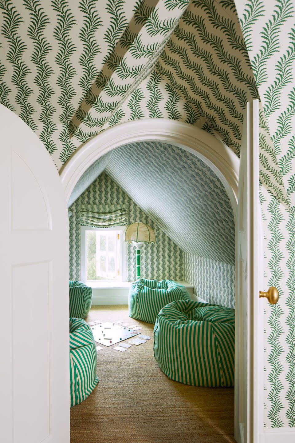 a room with a green couch and a lamp
