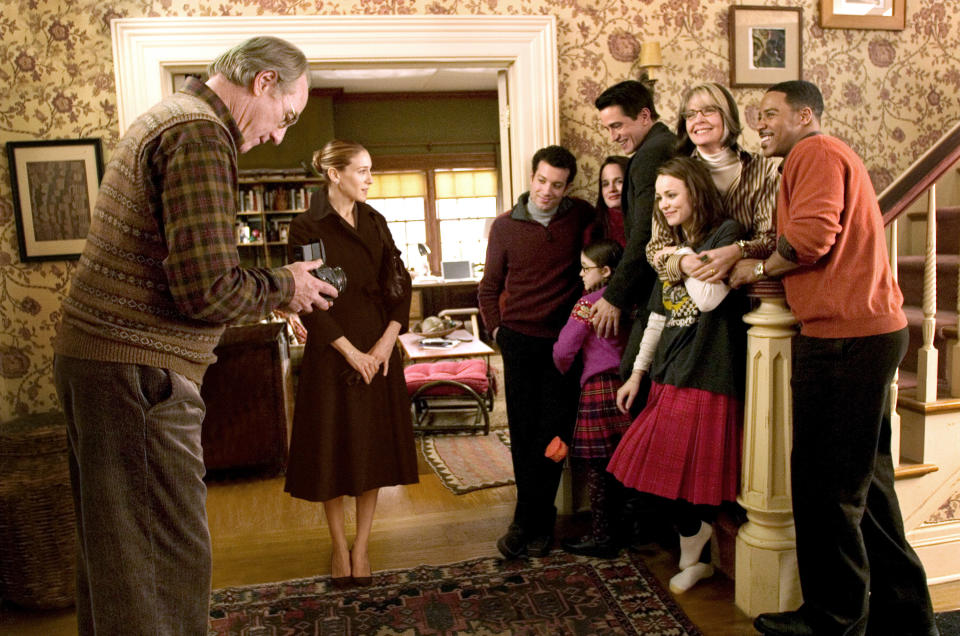 A family stands together on the stairs