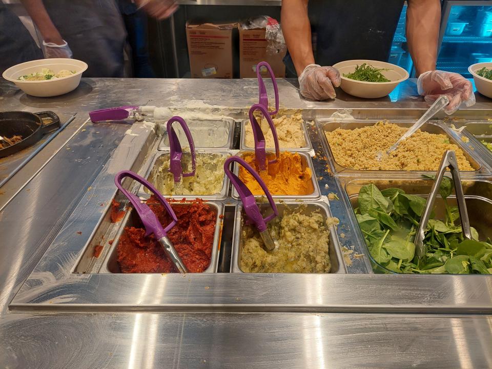 A range of sauces, salads and grains in trays at the Cava restaurant in Chicago