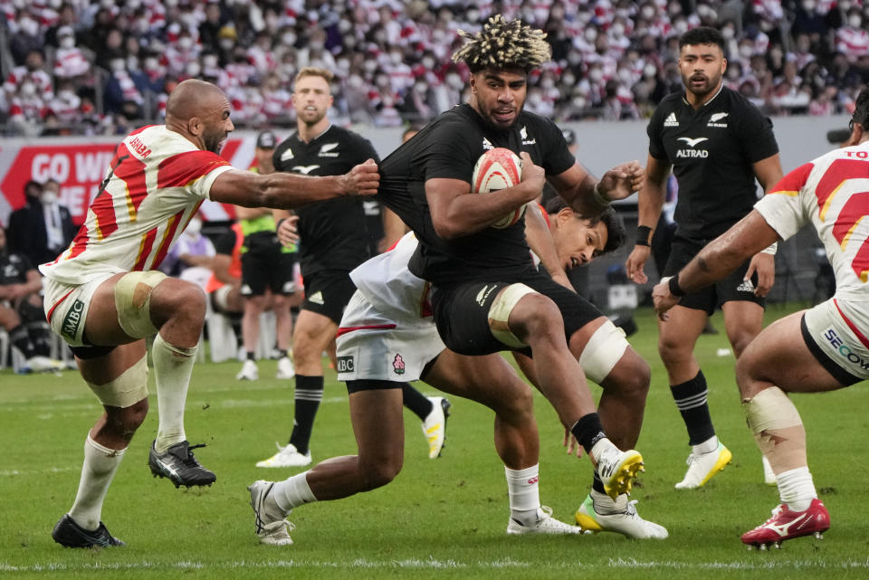 New Zealand's Hoskins Sotutu is tackled by Japan's Michael Leitch, left, as he heads for the try line during the rugby international between the All Blacks and Japan at the National Stadium in Tokyo, Japan, Saturday, Oct. 29, 2022. (AP Photo/Shuji Kajiyama)