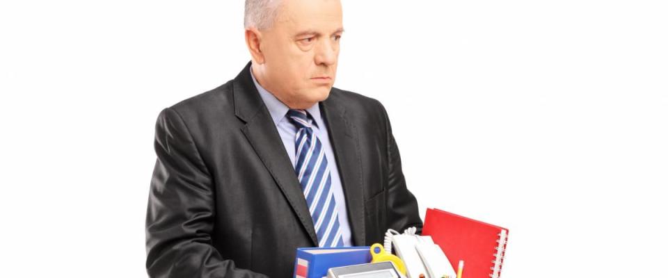 A fired professional man with a box of belongings, isolated on white background