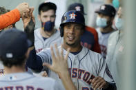 Houston Astros' Michael Brantley is greeted in the dugout after he scored on a single by Taylor Jones during the fourth inning of the team's baseball game against the Seattle Mariners, Saturday, April 17, 2021, in Seattle. (AP Photo/Ted S. Warren)