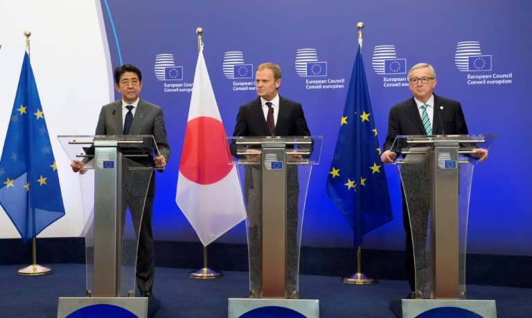 (From L) Japanese Prime Minister Shinzo Abe, EU President Donald Tusk and European Commission chief Jean-Claude Juncker hold a press conference prior to their meeting at the EU headquarters in Brussels on May 3, 2016