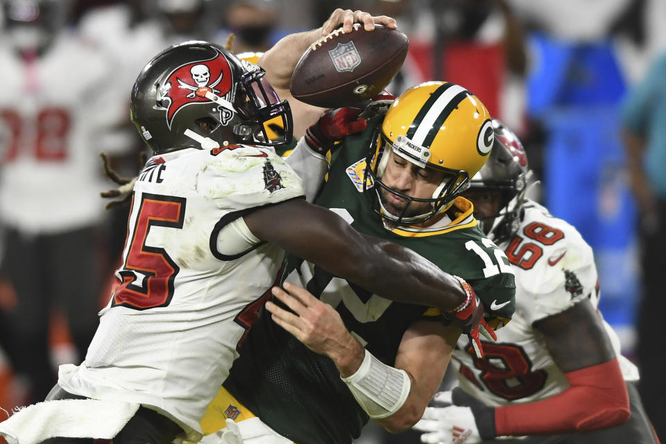 FILE - Tampa Bay Buccaneers inside linebacker Devin White (45) sacks Green Bay Packers quarterback Aaron Rodgers (12) during the second half of an NFL football game in Tampa, Fla., in this Sunday, Oct. 18, 2020, file photo. Rodgers had his worst game of the season in Green Bay’s 38-10 loss at Tampa Bay Back on Oct. 18, as he threw two game-changing interceptions and completed less than half his pass attempts. Rodgers gets a chance to make amends for that performance Sunday when the top-seeded Packers host the Bucs in the NFC championship game. (AP Photo/Jason Behnken, File)