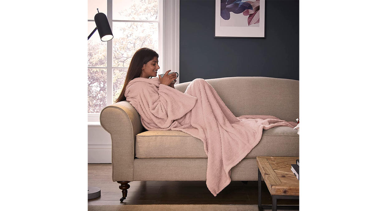 This extra-long, oversized blanket has spacious sleeves and a foot pocket.