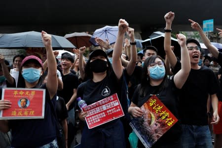 Anti-extradition bill protesters shout slogans to Chinese tourists during a march to West Kowloon Express Rail Link Station in Hong Kong