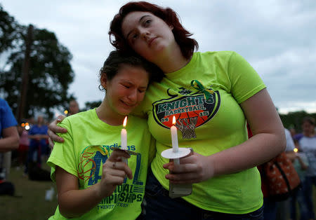 Mourners attend a vigil in memory of the victims killed in a shooting at Santa Fe High School in League City, Texas, U.S., May 20, 2018. REUTERS/Jonathan Bachman