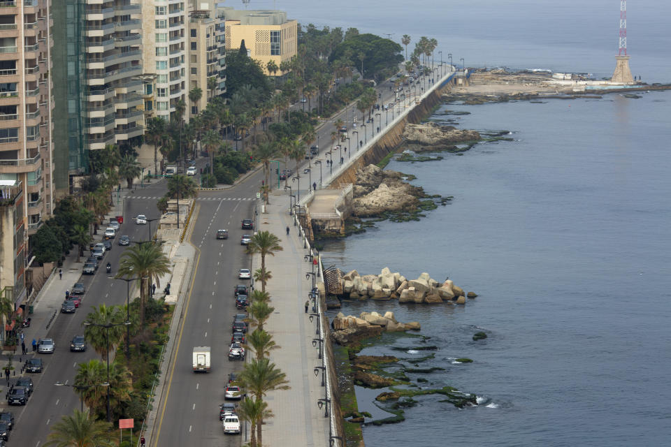 An aerial view shows the waterfront promenade along the Mediterranean Sea being mostly empty after police order people to vacate it in Beirut, Lebanon, Monday, March 16, 2020. For most people, the new coronavirus causes only mild or moderate symptoms, such as fever and cough. For some, especially older adults and people with existing health problems, it can cause more severe illness, including pneumonia. (AP Photo/Hassan Ammar)