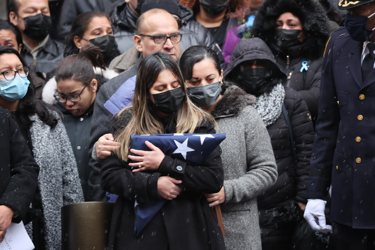 Dominique Rivera, the wife of fallen NYPD Officer Jason Rivera, holds a flag from his casket during his funeral at St. Patrick's Cathedral on January 28, 2022 in New York City. The 22-year-old NYPD officer was shot and killed on January 21 in Harlem while (Spencer Platt / Getty Images)