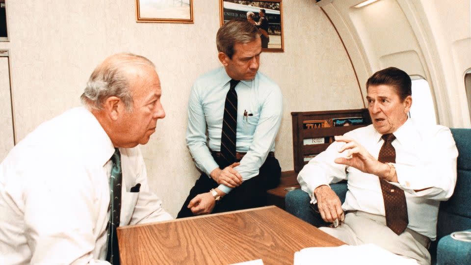 Secretary of State George Shultz and National Security Advisor-designate Robert McFarlane listen to Reagan speak about the ongoing issues in Beirut on Air Force One on October 23, 1983. - Bill Fitz-Patrick/The White House/Getty Images