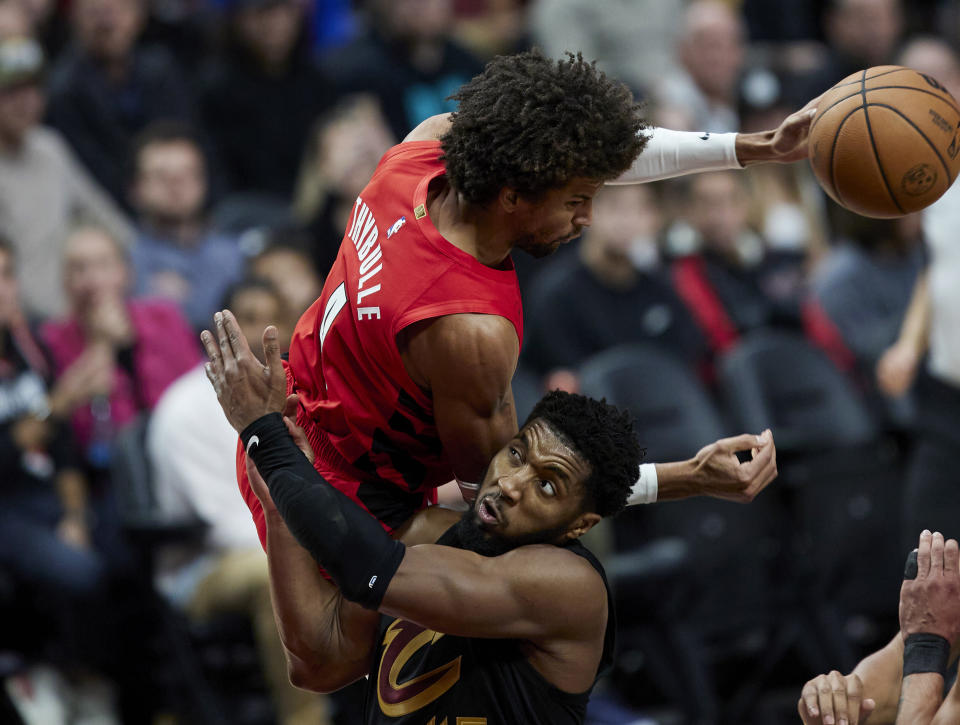 Portland Trail Blazers guard Matisse Thybulle, top, collides with Cleveland Cavaliers guard Donovan Mitchell during the second half of an NBA basketball game in Portland, Ore., Wednesday, Nov. 15, 2023. (AP Photo/Craig Mitchelldyer)