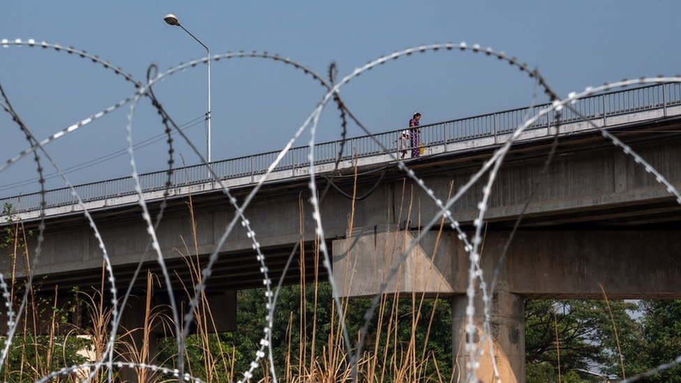 Burmese crossing the border bridge to Mae Sot, Thailand