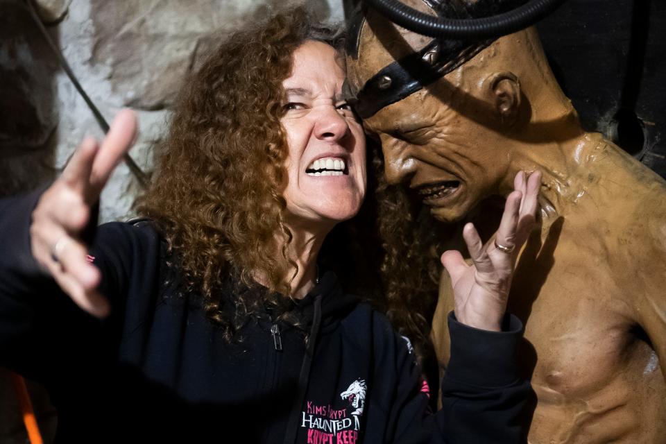 Owner and operator Kim Yates poses for a photo with one of her Distortions Electric Chair Animatronics at Kim's Krypt Haunted Mill in Heidelberg Township on April 12, 2024, the day a film crew from a paranormal TV show visited her business.