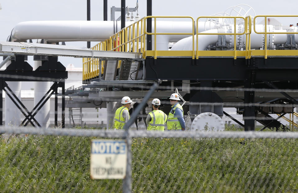 FILE - In this June 29, 2018 file photo, workers are visible at the Superior terminal of Enbridge Energy in Superior, Wis. Enbridge says the upgrade and expansion of its Line 3 pipeline across Minnesota is complete and will become operational on Friday, Oct. 1, 2021. The Canadian-based company's President and CEO Al Monaco said in a statement Wednesday that the pipeline “will soon deliver the low-cost and reliable energy that people depend on every day.” (AP Photo/Jim Mone File)