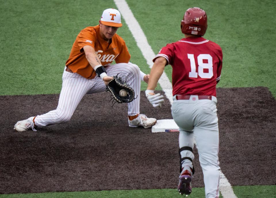 Texas first baseman Jared Thomas makes the catch ahead of Oklahoma base runner Caden Powell in the fifth inning of their game on April 22. Having a lefty play at first base helps a lot in terms of teammates throwing to first or securing a double play, UT coach David Pierce said.