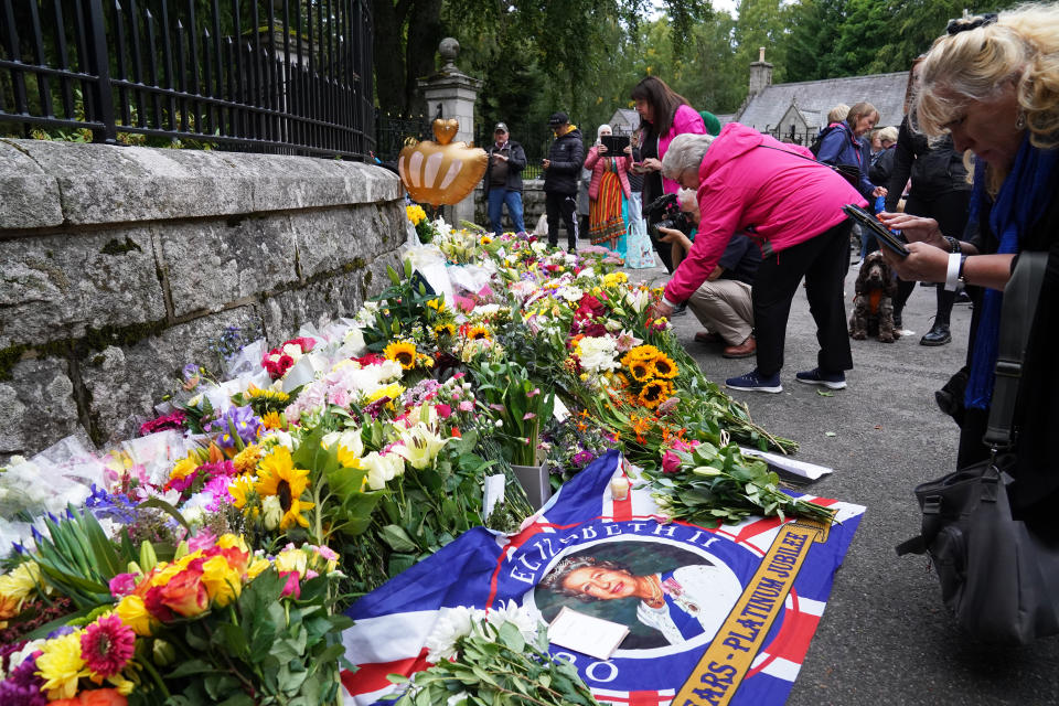 Floral tributes are laid at the gates of Balmoral in Scotland following the death of Queen Elizabeth II on Thursday. Picture date: Friday September 9, 2022.