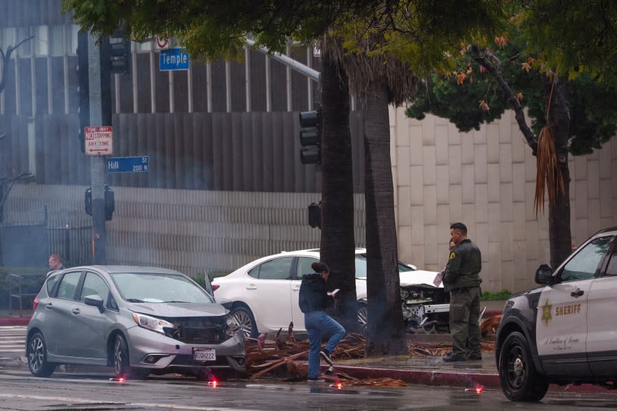 Los Angeles Sheriff officers help two motorists involved in a traffic collision at a busy intersection with a non working traffic signals due to power outage on Monday, Feb. 5, 2024, in Los Angeles. A storm of historic proportions has unleashed record levels of rain over parts of Los Angeles. The weather is endangering the city’s large homeless population, sending mud and boulders down hillsides dotted with multimillion-dollar homes and knocking out power for about 830,000 people in California. (AP Photo/Damian Dovarganes)