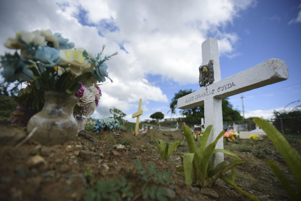 This Sept. 8, 2018 photo shows the burial site of Argeo Caraballo at the municipal cemetery in Vieques, Puerto Rico. Argeo, 70, was one of the dialysis patients who died hoping the mobile unit that federal officials purchased to provide dialysis on Vieques would arrive after Hurricane Maria ruined the only dialysis center on this tiny island . "The trips were way too exhausting," said his daughter, who would travel with her father to the Puerto Rican mainland for his treatments three times a week. The mobile unit remains stuck in California. (AP Photo/Carlos Giusti)