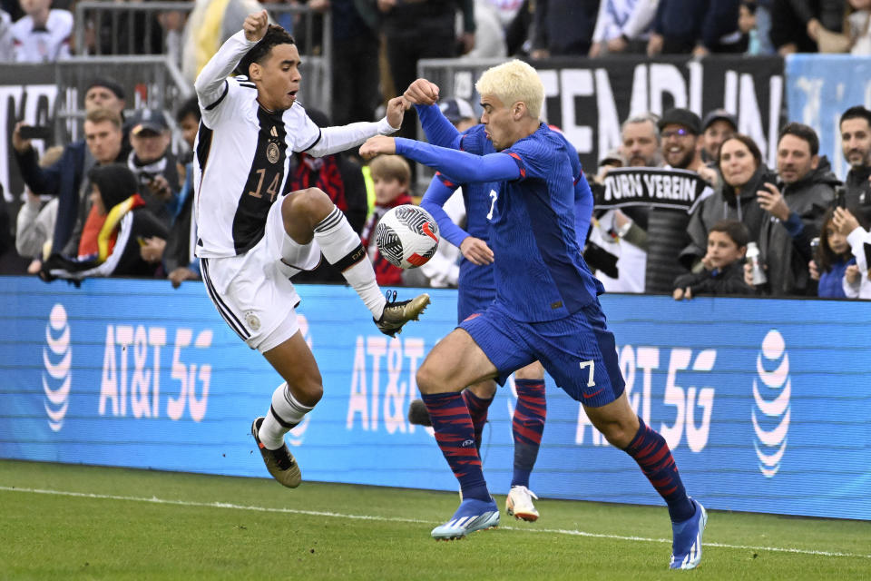 Germany's Jamal Musiala, left, and United States' Gio Reyna, right, battle for the ball during an international friendly soccer match at Pratt & Whitney Stadium at Rentschler Field, Saturday, Oct. 14, 2023, in East Hartford, Conn. (AP Photo/Jessica Hill)