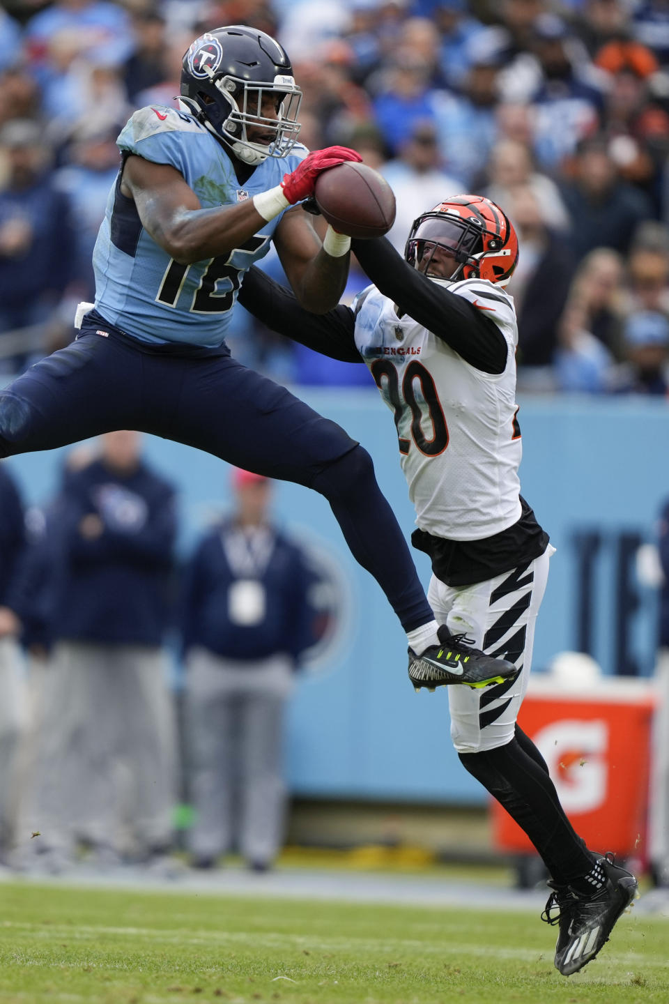 Tennessee Titans wide receiver Treylon Burks (16) leaps for a pass against Cincinnati Bengals cornerback Eli Apple (20) during the first half of an NFL football game, Sunday, Nov. 27, 2022, in Nashville, Tenn. (AP Photo/Gerald Herbert)