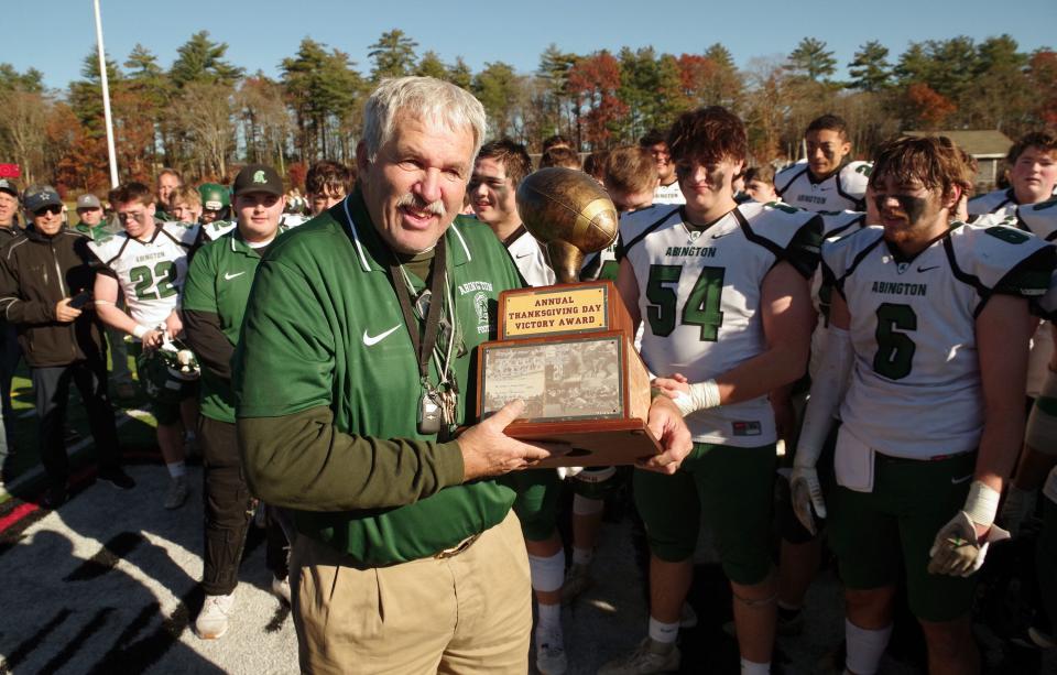 Jim Kelliher holds the last Thanksgiving Day Victory on behalf of the Abington Green Wave, having beaten Whitman-Hanson in his 50th and final year as head coach, on Thanksgiving Day, Nov. 23, 2023.