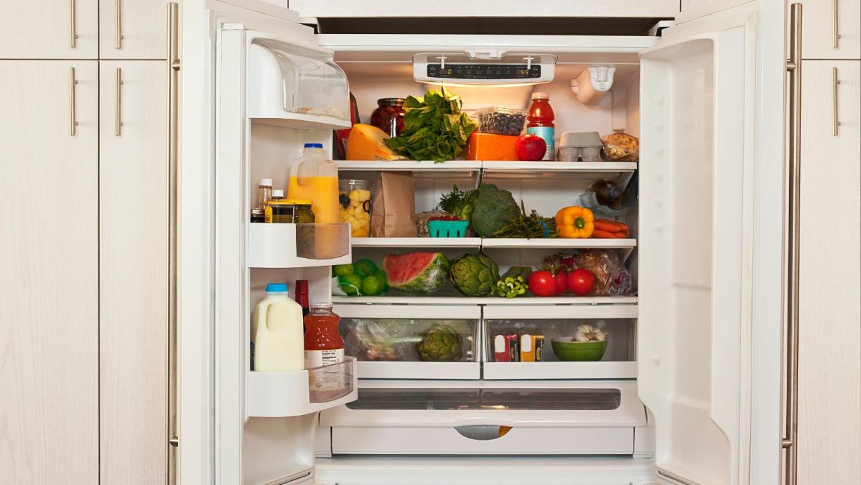  An open fridge fully stocked with healthy food  