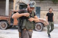 Free Syrian Army fighters walk in the rebel-held al-Myassar neighbourhood of Aleppo, Syria, September 27, 2016. REUTERS/Abdalrhman Ismail