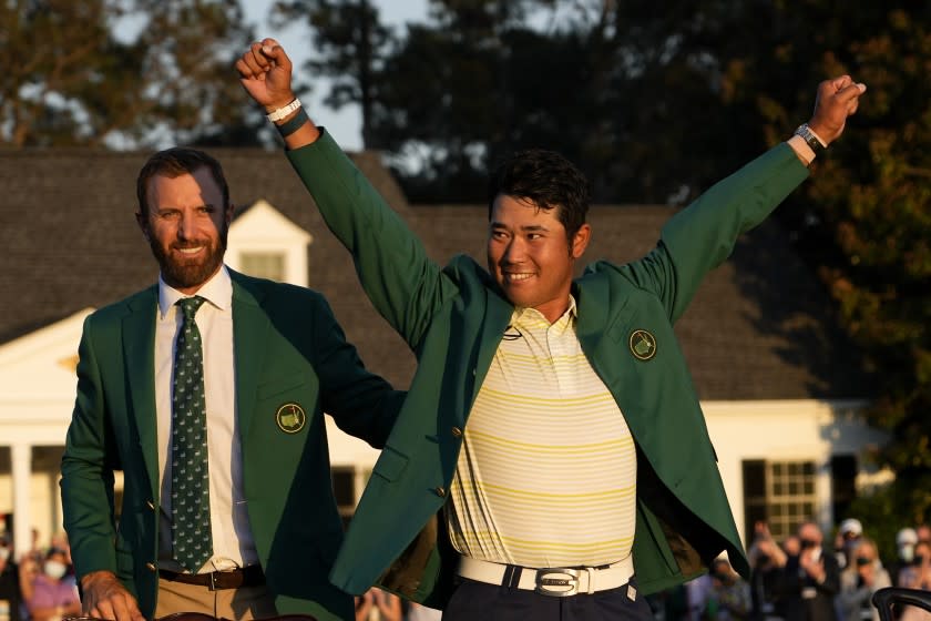 Hideki Matsuyama, of Japan, puts on the champion's green jacket after winning the Masters golf tournament.