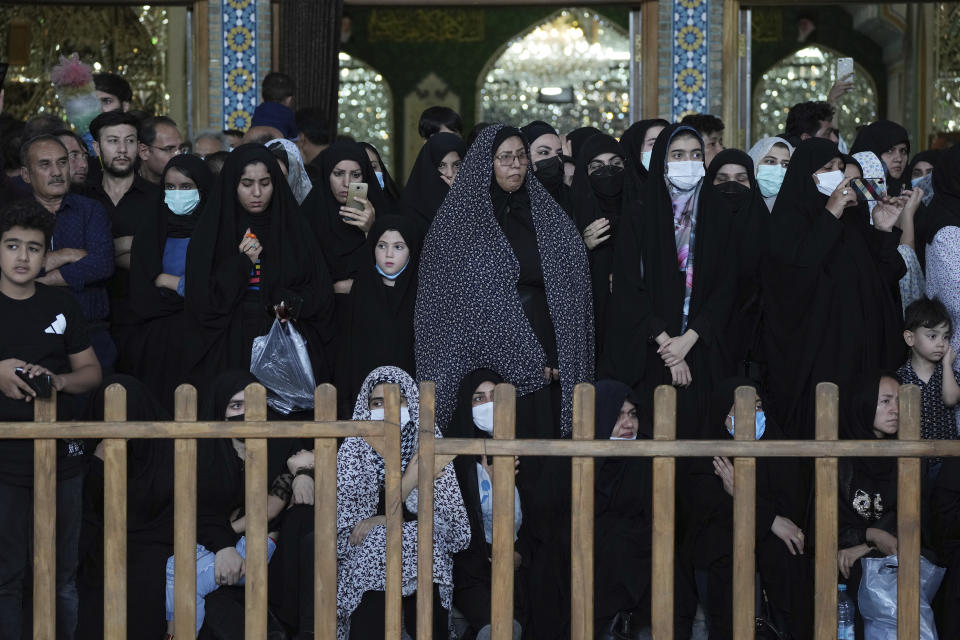 Mourners attend an annual procession commemorating Ashoura which marks the death anniversary of Imam Hussein, the grandson of Prophet Muhammad, who was killed with 72 of his companions in the 7th century in the Battle of Karbala in present-day Iraq, in Tehran, Iran, Monday, Aug. 8, 2022. (AP Photo/Vahid Salemi)