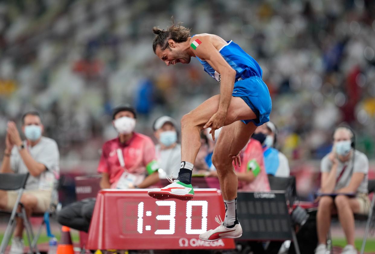 Gianmarco Tamberi, of Italy reacts after he wins joint gold with Mutaz Barshim of Qatar in the final of the men's high jump at the 2020 Summer Olympics, Sunday, Aug. 1, 2021, in Tokyo, Japan.