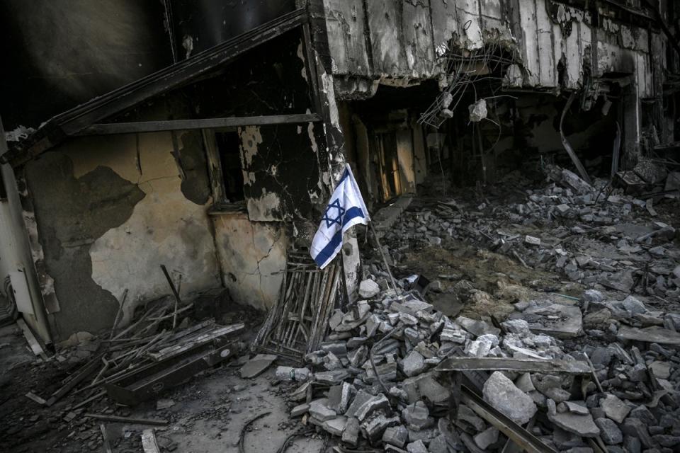 An Israeli flag placed at a destroyed house in Kibbutz Beeri, nearly a month after the 7 October attack by Palestinian militants (AFP via Getty Images)