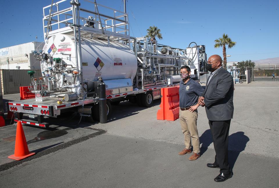 Rep. Raul Ruiz, left, and Indio mayor Waymond Fermon watch a demonstration of Sunline's submerged liquid hydrogen pump in Indio, Calif., Wednesday, January 19, 2022.