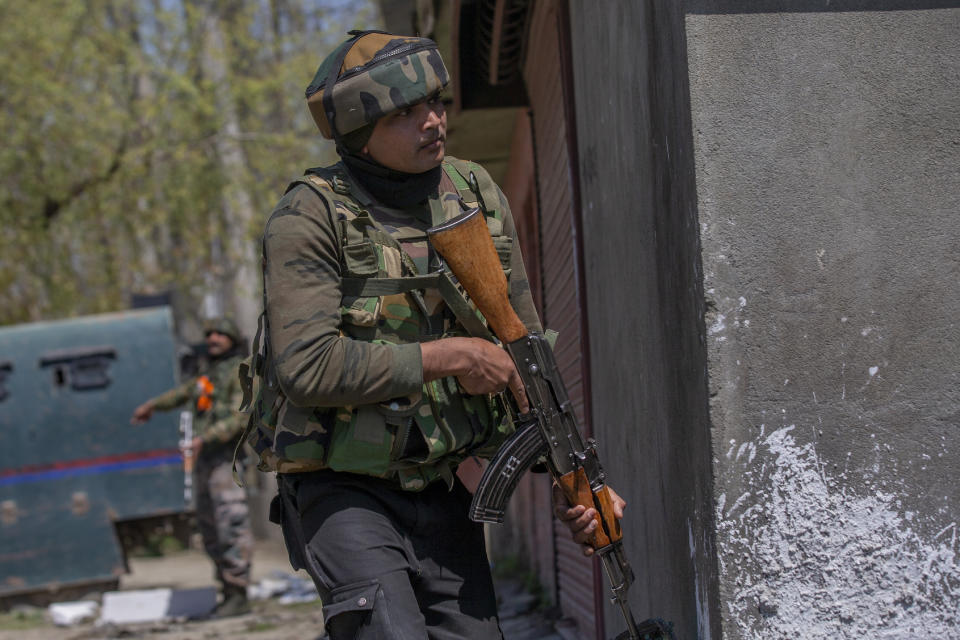 Indian army officers stand guard at the site of a shootout on the outskirts of Srinagar, Indian controlled Kashmir, Thursday, April 1, 2021. Gunmen in disputed Kashmir on Thursday killed a policeman as they tried to storm the residence of a politician of India's ruling party, police said. (AP Photo/ Dar Yasin)