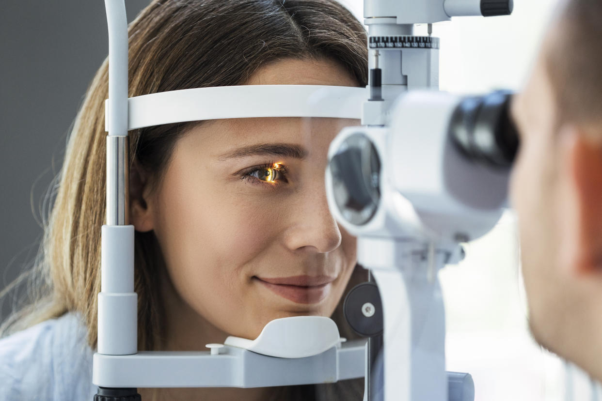 Beautiful young girl checking the eye vision in modern ophthalmology clinic retinal detachment