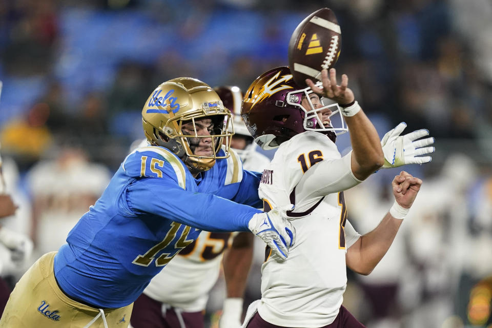 FILE - UCLA defensive lineman Laiatu Latu, left, pressures Arizona State quarterback Trenton Bourguet during the second half of an NCAA college football game Saturday, Nov. 11, 2023, in Pasadena, Calif. (AP Photo/Ryan Sun, File)