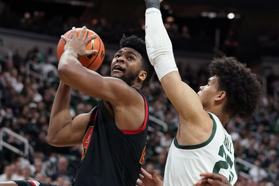 Maryland forward Donta Scott (24) is defended by Michigan State forward Malik Hall during the first half of an NCAA college basketball game, Sunday, March 6, 2022, in East Lansing, Mich. (AP Photo/Carlos Osorio)