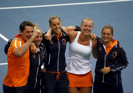 Members of the Netherlands team pose for pictures as they celebrate their victory over Russia in their Fed Cup World Group tennis match in Moscow February 7, 2016. REUTERS/Maxim Shemetov